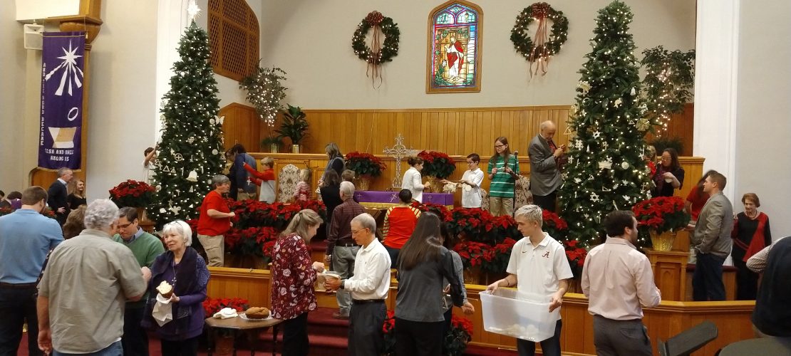 people taking communion and putting up Christmas decorations
